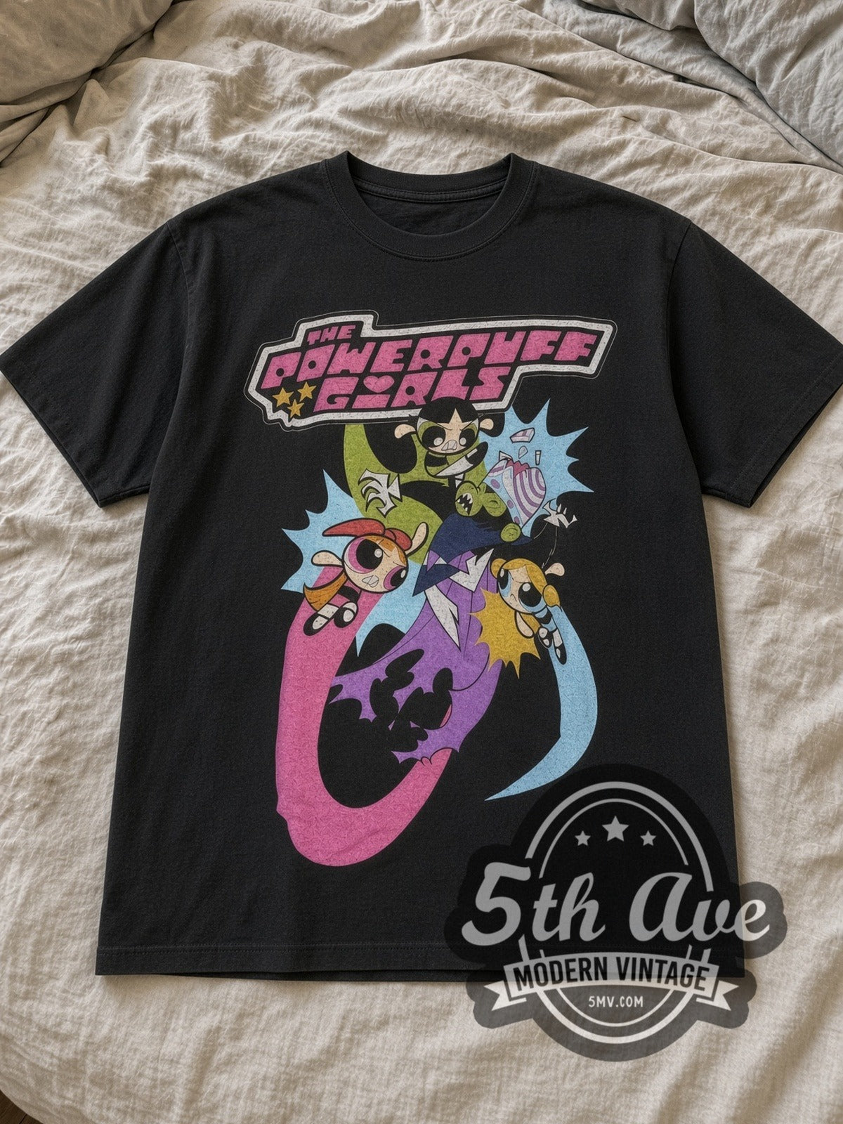 Black The Powerpuff Girls Vs. Mojo Jojo Vintage Cartoon T-Shirt laid flat on a linen bed