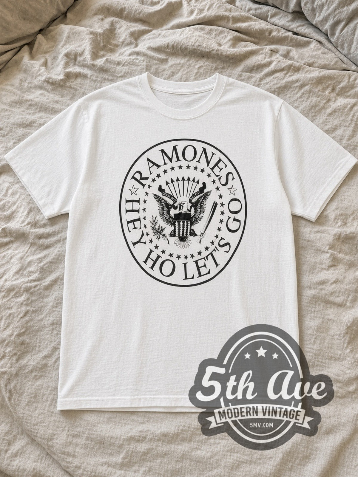 White The Ramones Hey! Ho! Let's Go Anthology Vintage Band T-Shirt laid flat on a linen bed