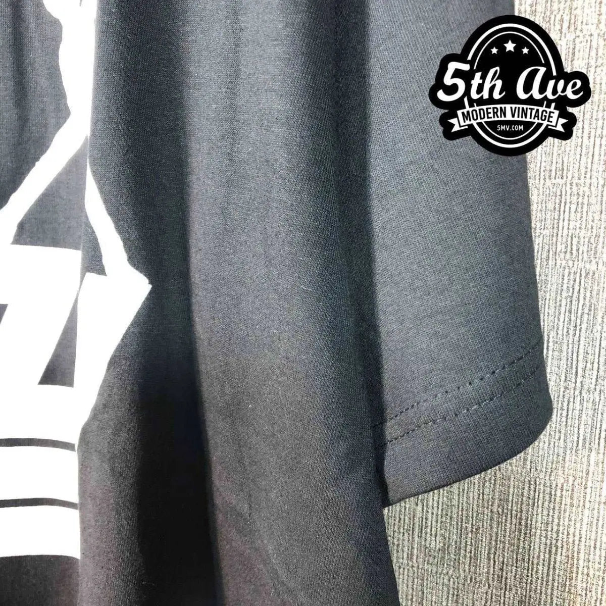 Model wearing Thin Lizzy – Stacked White Logo Guitarist Silhouette vintage band tee