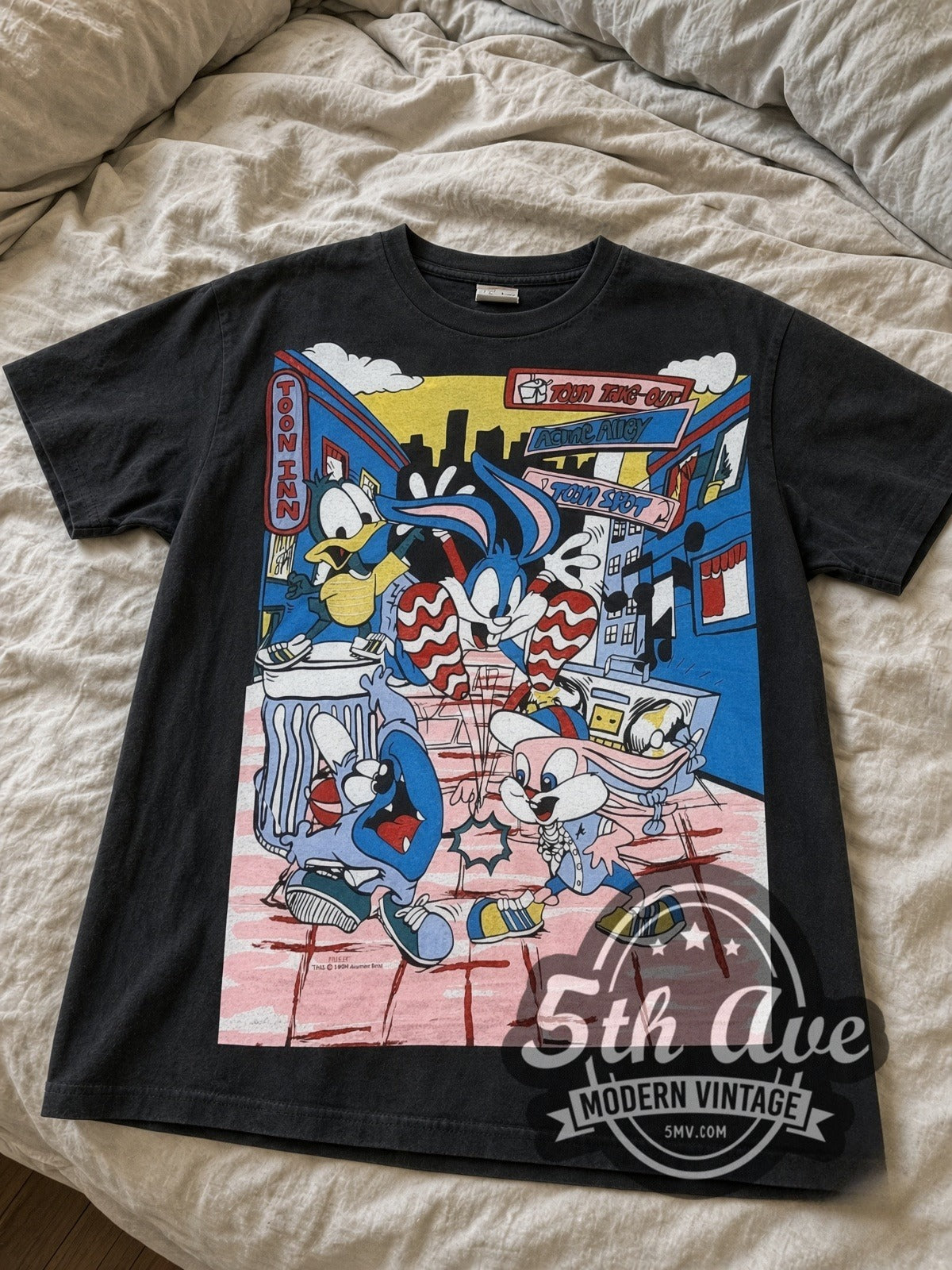 Tiny Toon Adventures Toon Town Crew all-over-print vintage cartoon tee in black laid flat