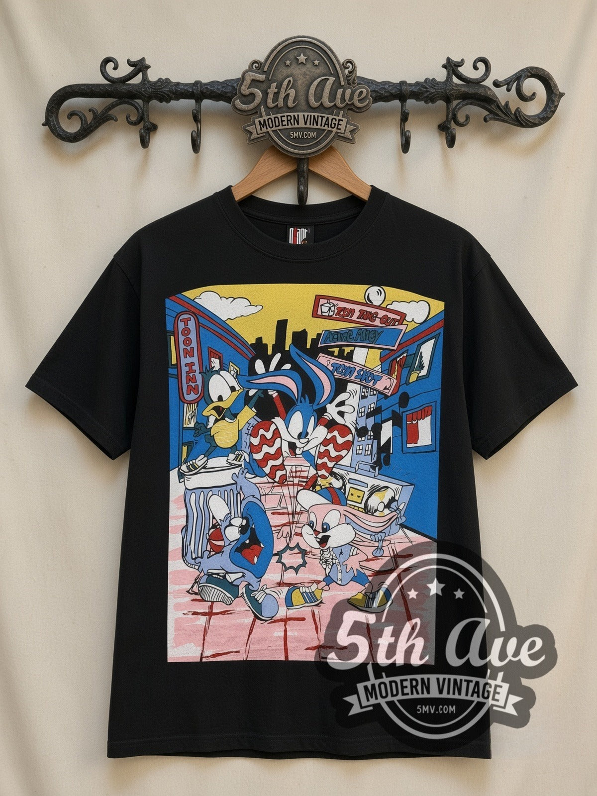 Tiny Toon Adventures Toon Town Crew all-over-print vintage cartoon t-shirt in black, front view on a display rack