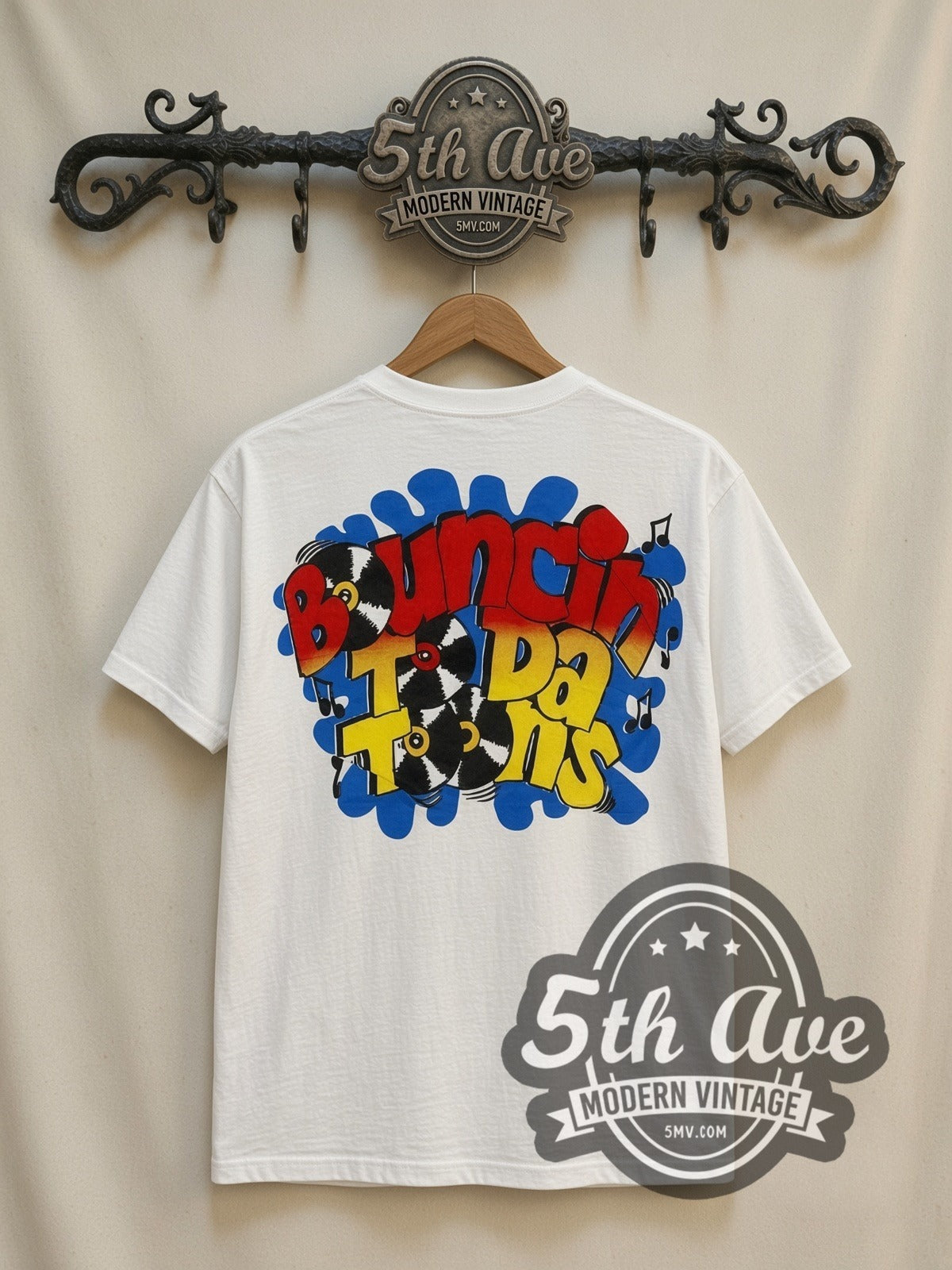Tiny Toon Adventures Toon Town Crew all-over-print vintage cartoon t-shirt in white, back view on a display rack