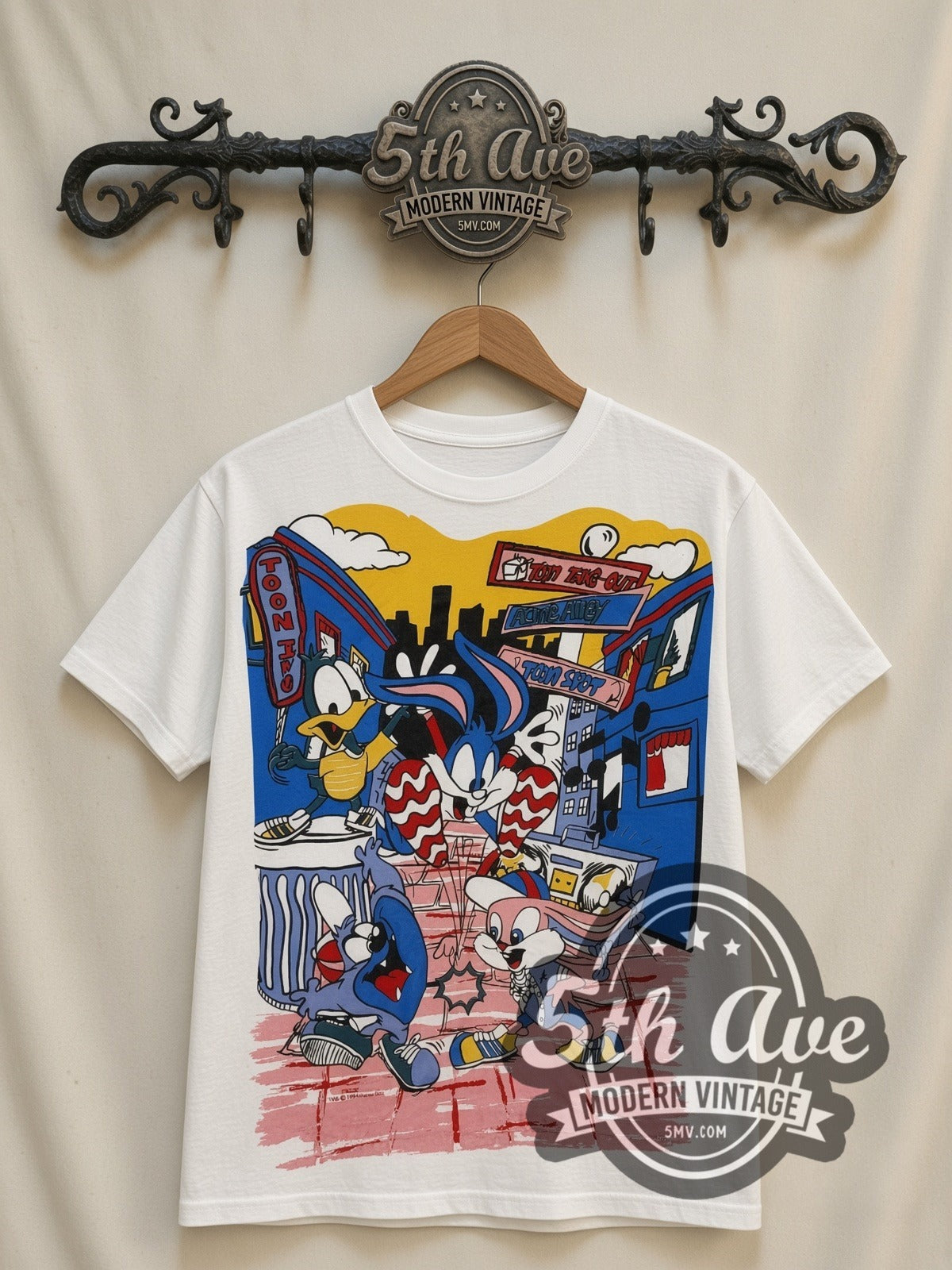 Tiny Toon Adventures Toon Town Crew all-over-print vintage cartoon t-shirt in white, front view on a display rack