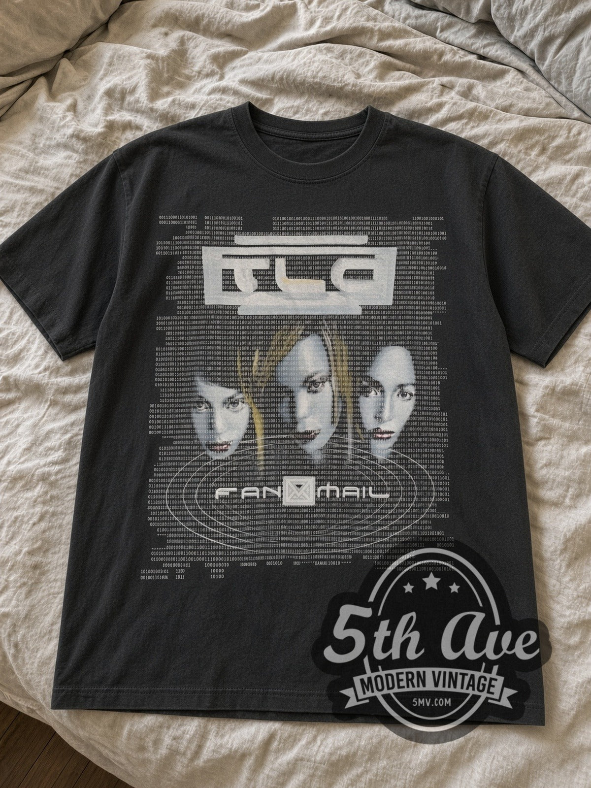 Black TLC FanMail tour tee laid flat on linen bed