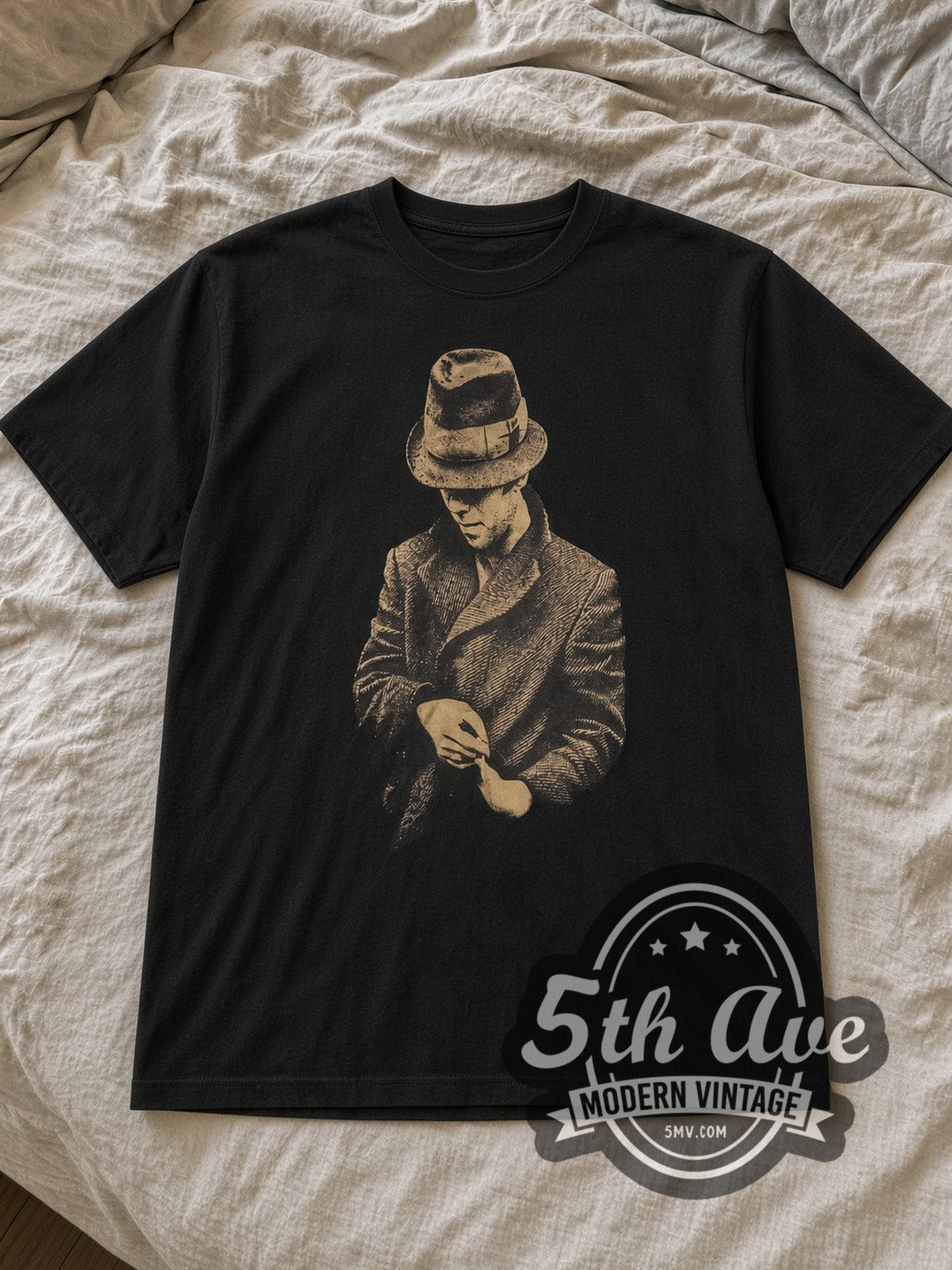 Black Tom Waits Vintage Band T-Shirt laid flat on a linen bed