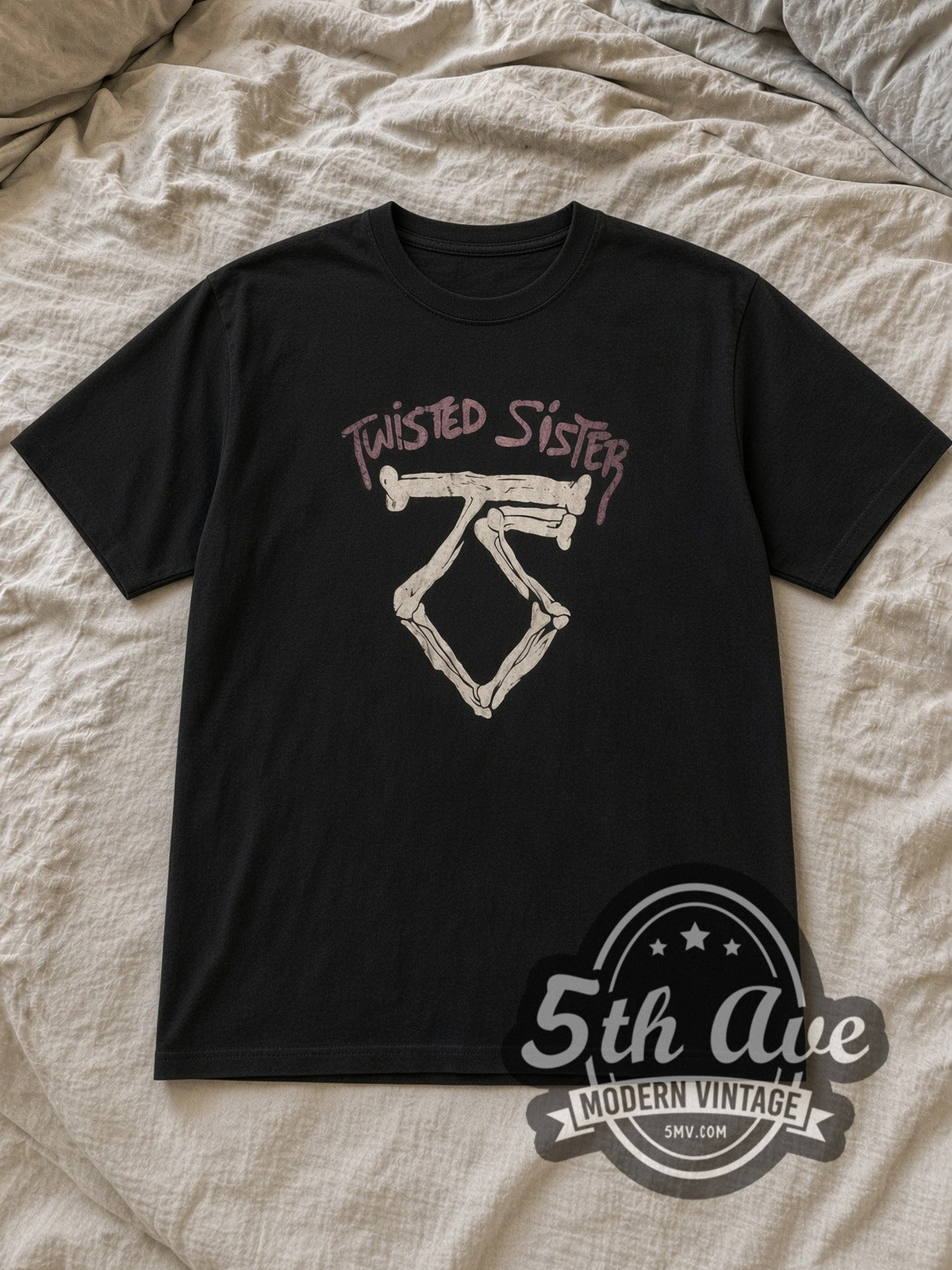 Black Twisted Sister Bone TS Logo Pink Band Name Vintage Band T-Shirt laid flat on a linen bed