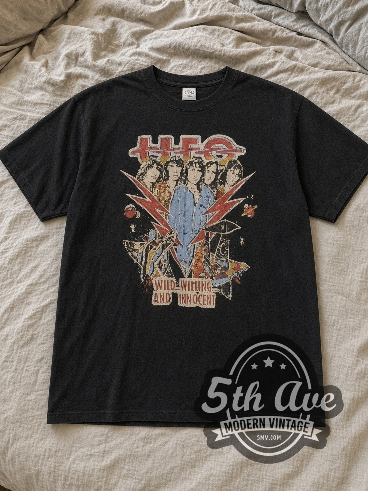 Black UFO Graphic Vintage Band T-Shirt laid flat on a linen bed