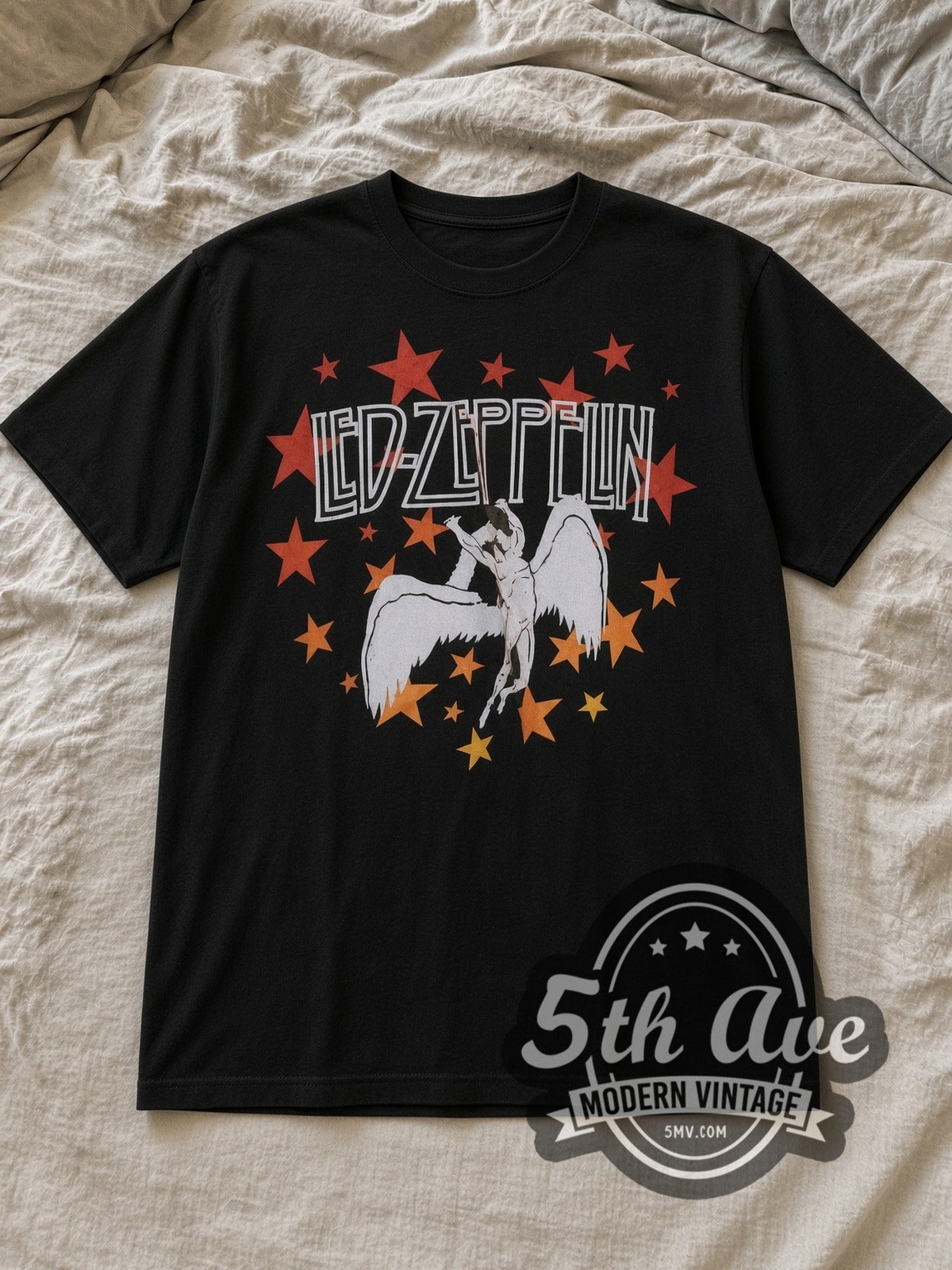 Black Led Zeppelin 1977 Tour Vintage Band T-Shirt laid flat on a linen bed