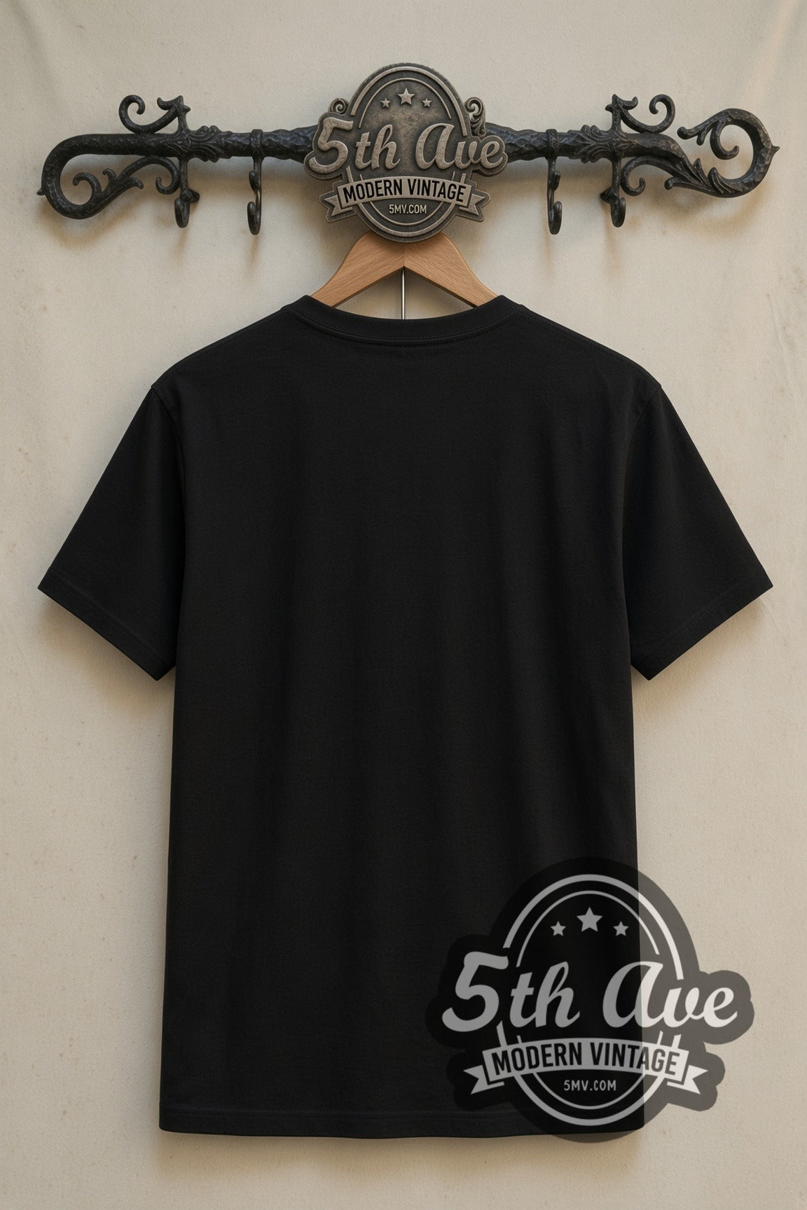 Plain black back of Wednesday Dancing Wednesday Monsters We Least Suspect double stitched tee on rack