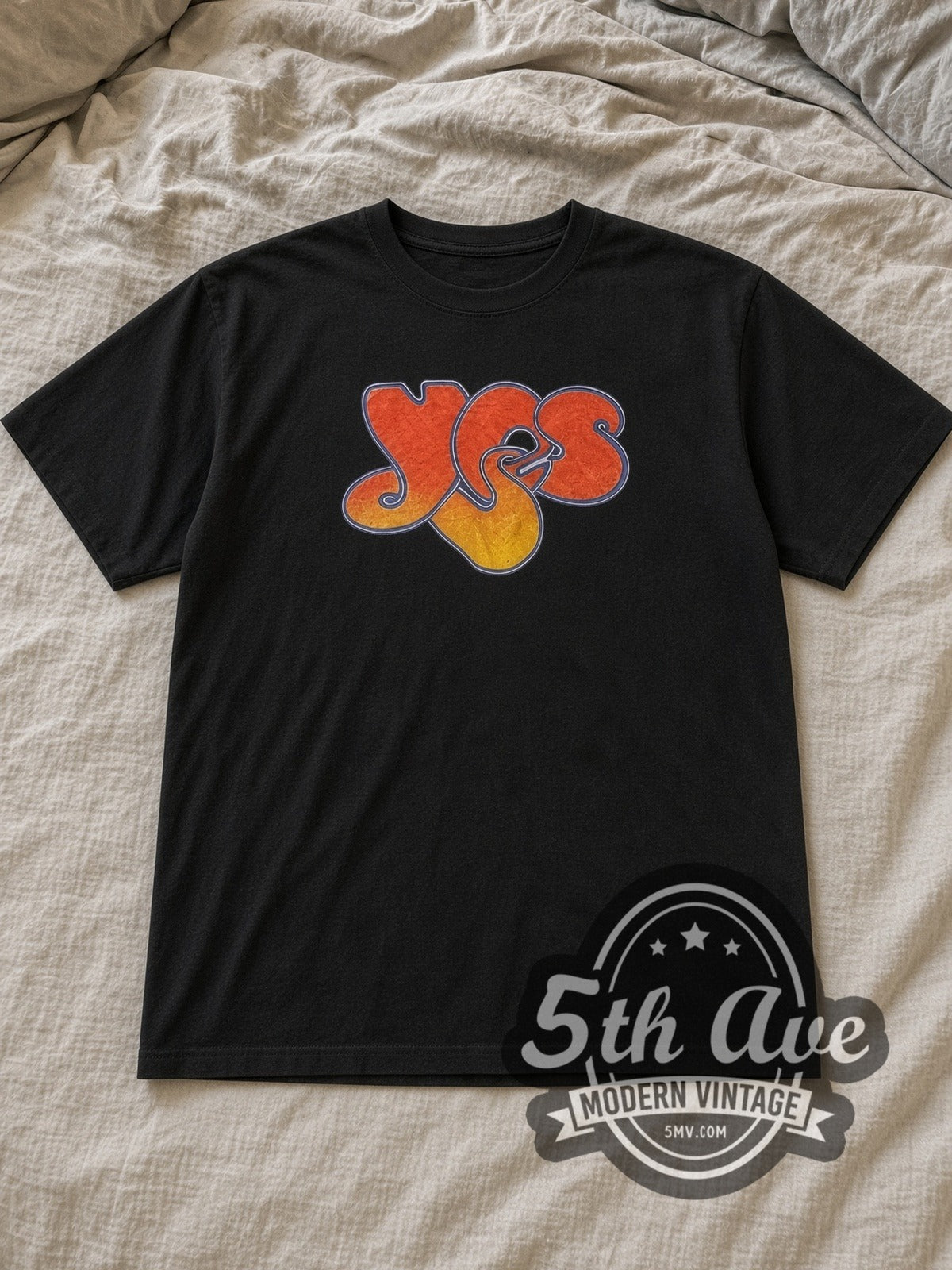 Black Yes Classic Logo Vintage Band T-Shirt laid flat on a linen bed