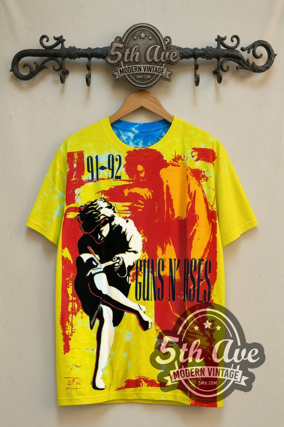 Guns N' Roses Use Your Illusion Tour vintage band t-shirt, yellow front view on a display rack