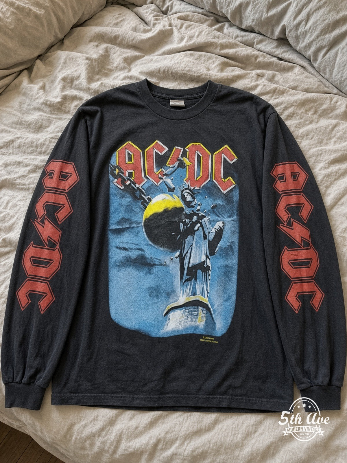 ETS LS 08 AC/DC Wrecking Ball long sleeve vintage tee laid on a bed