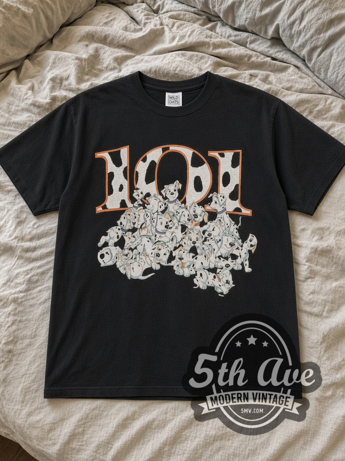 Black 101 Dalmatians 101 Puppies Pile Vintage Cartoon T-Shirt laid flat on a linen bed