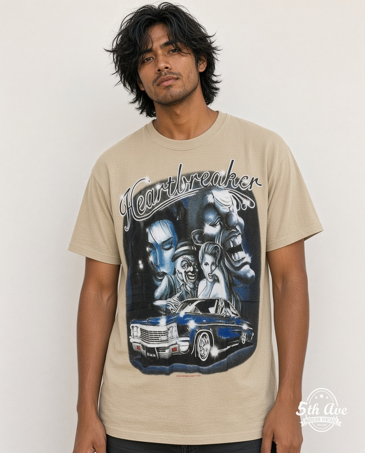 Model wearing the Rollin Hard Heartbreaker Lowrider graphic tee in sand