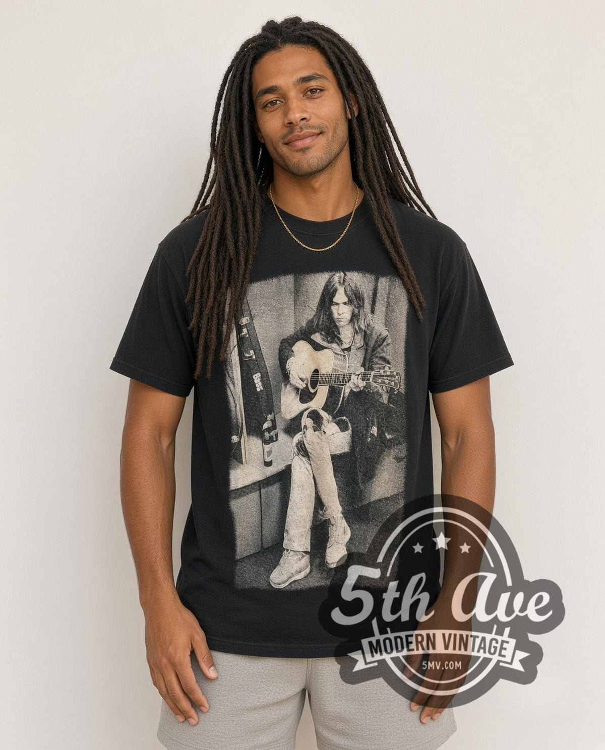 Model wearing the Neil Young Acoustic Guitar Bass Case Portrait vintage band t-shirt