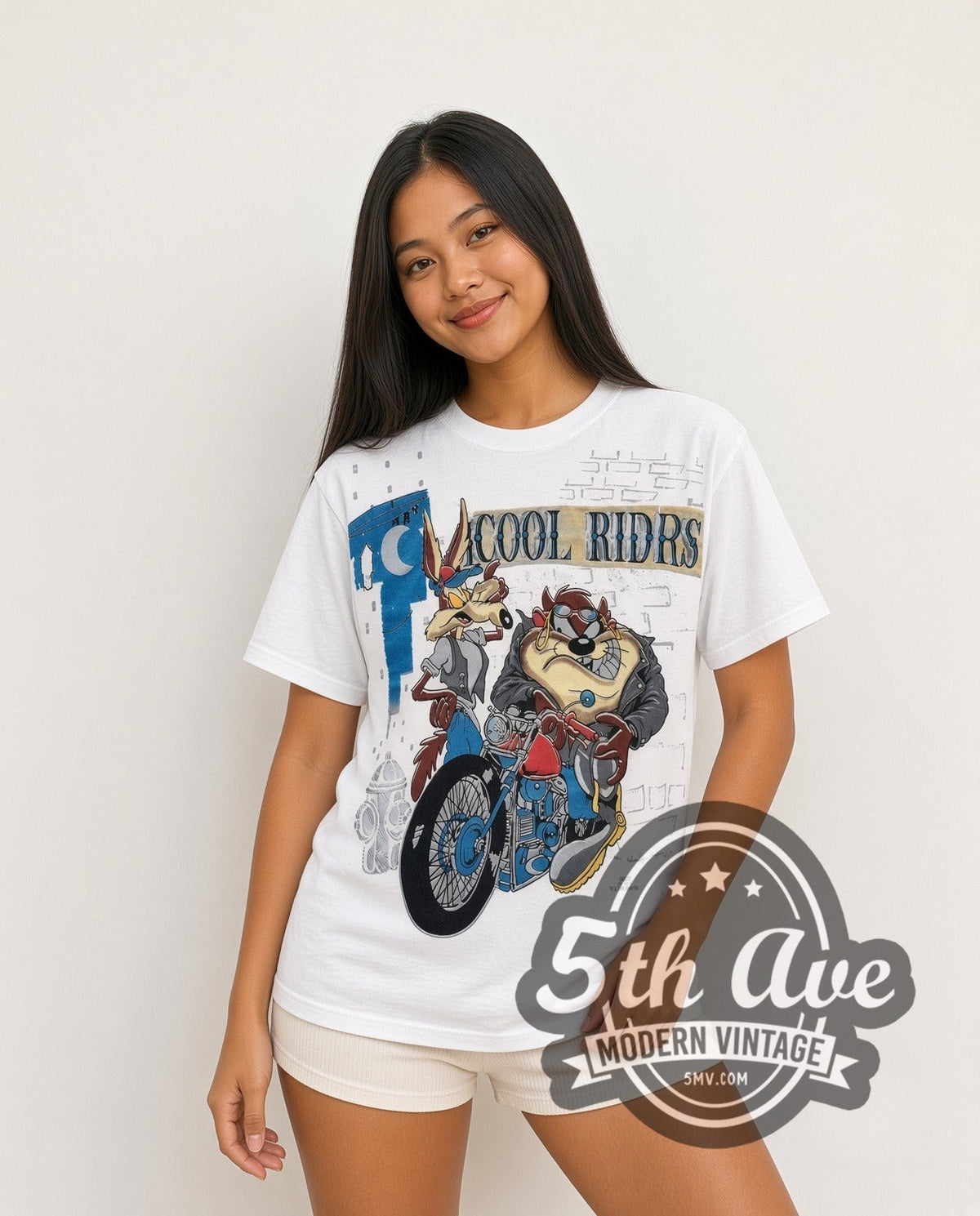 Model wearing the Looney Tunes Cool Riders Taz & Wile E all-over-print vintage cartoon t-shirt in white
