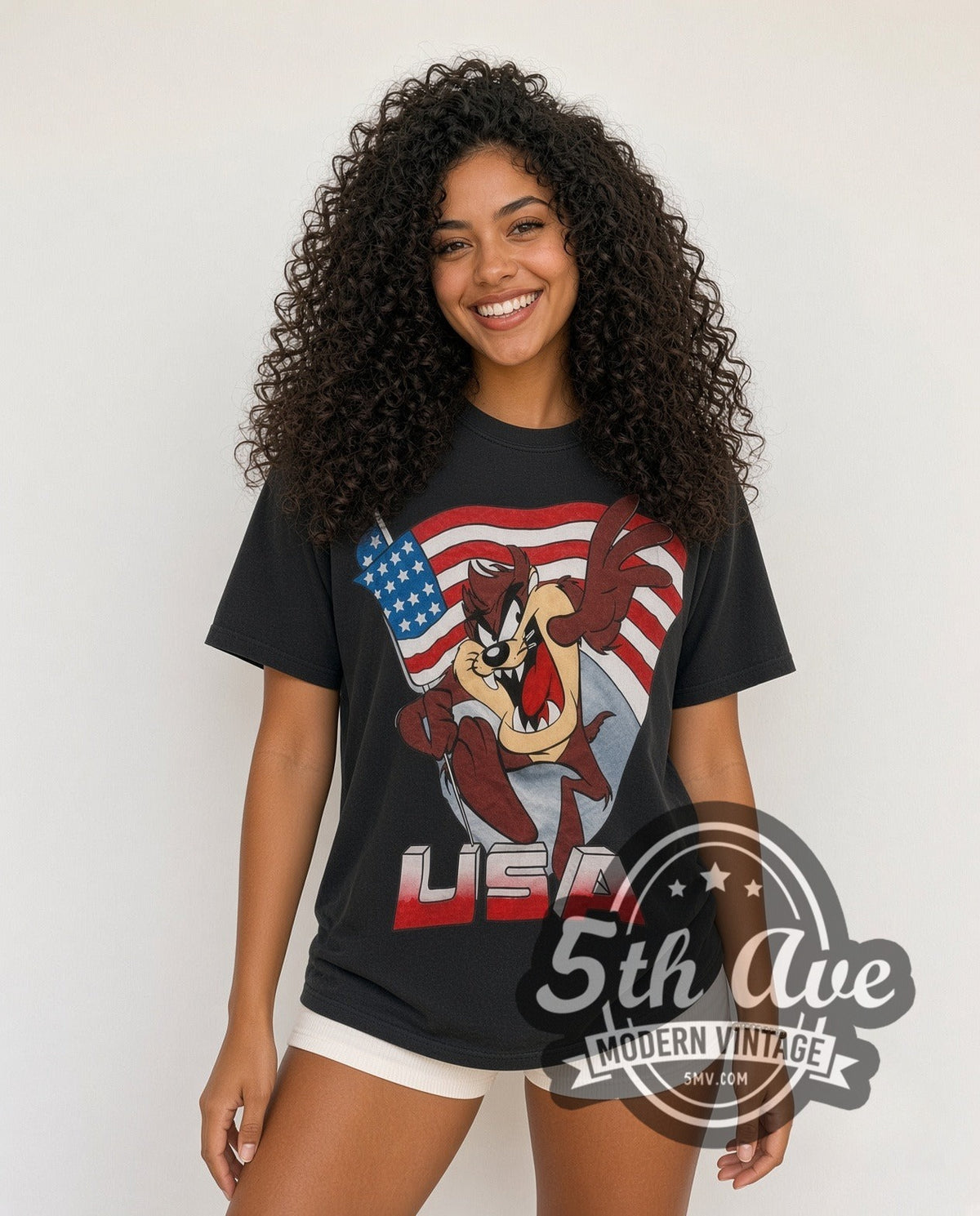 Model wearing the Looney Tunes Taz USA Flag all-over-print vintage cartoon t-shirt in black