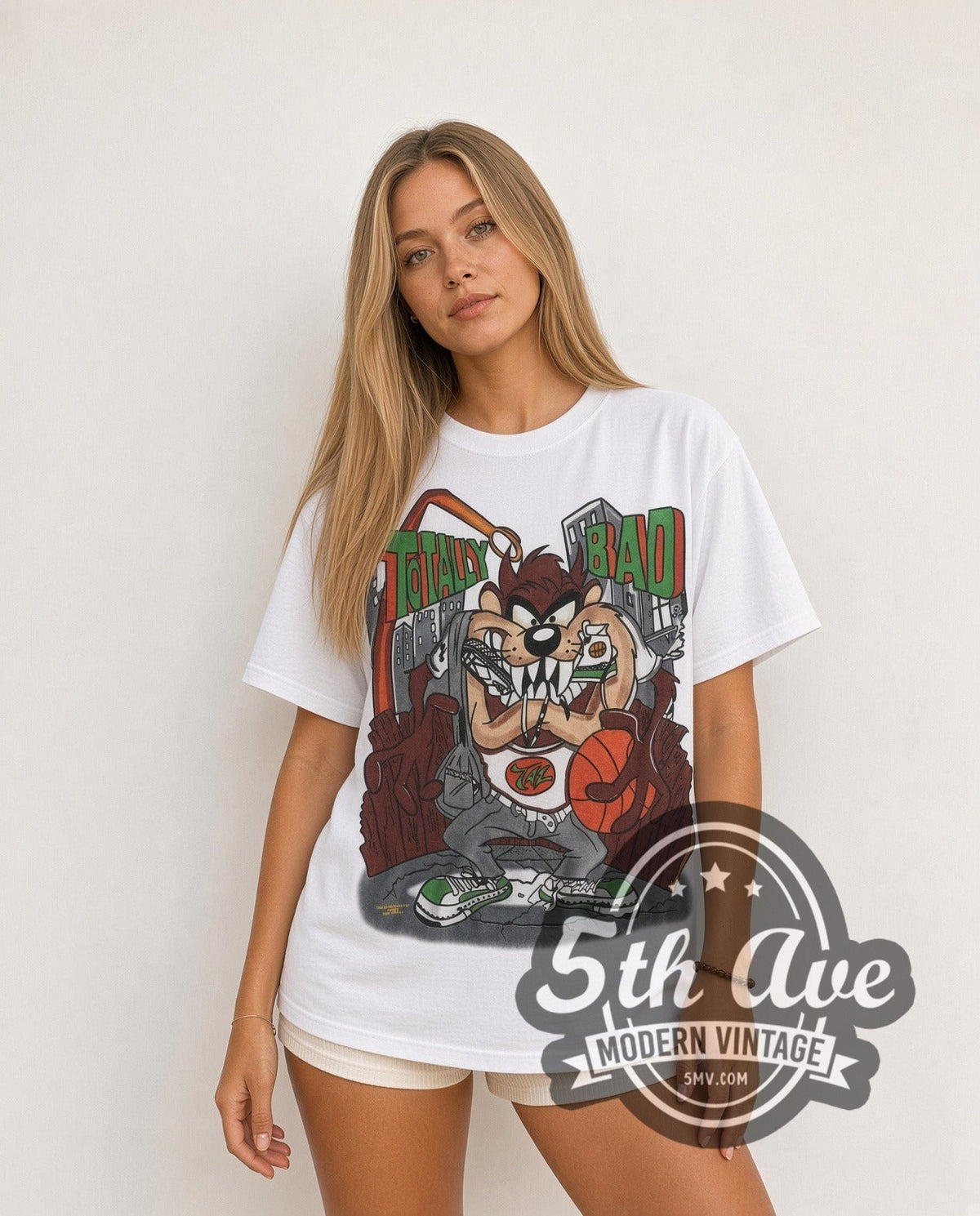 Model wearing the Looney Tunes Taz Totally Bad all-over-print vintage cartoon t-shirt in white