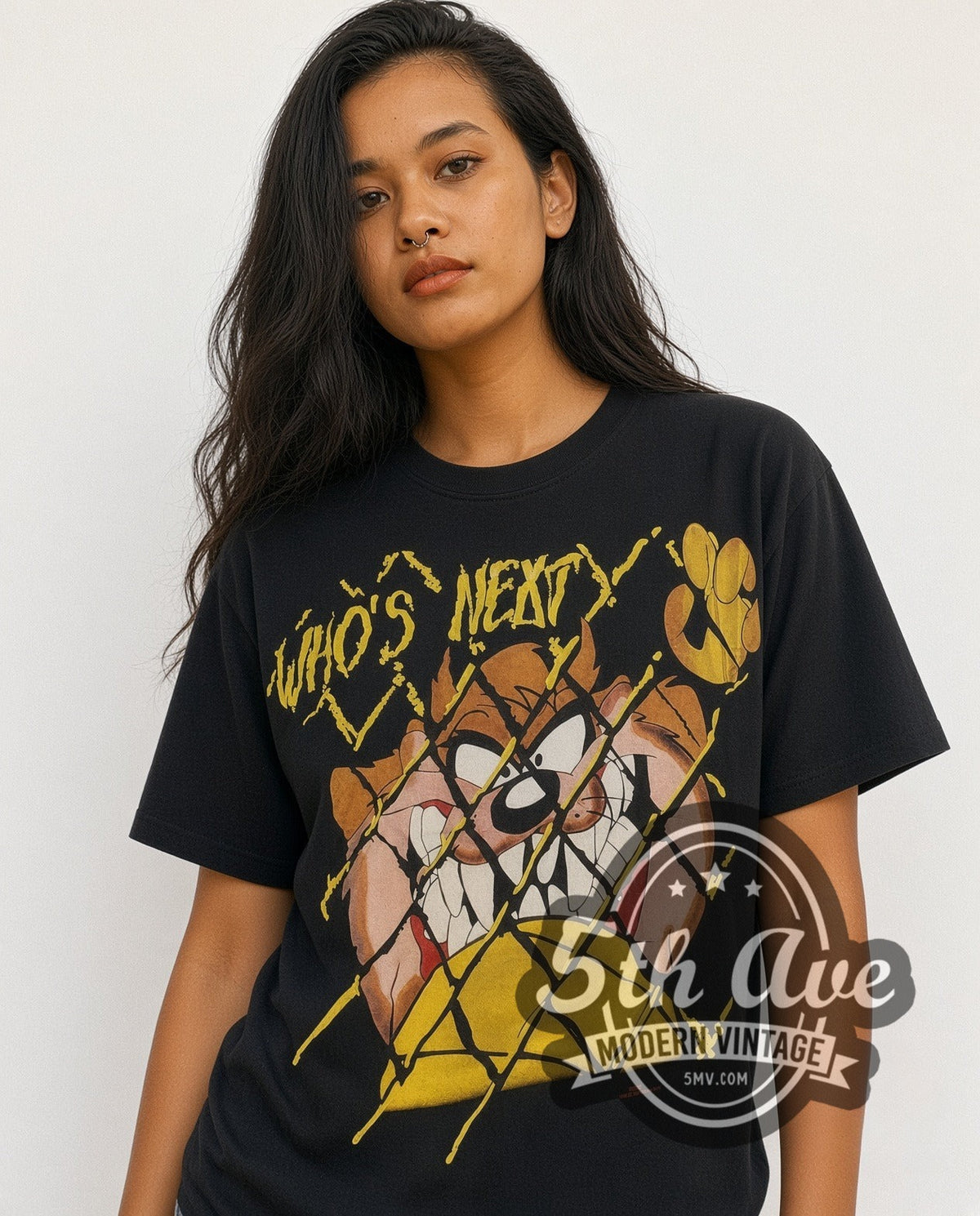 Model wearing the Looney Tunes Taz Who's Next all-over-print vintage cartoon t-shirt in black