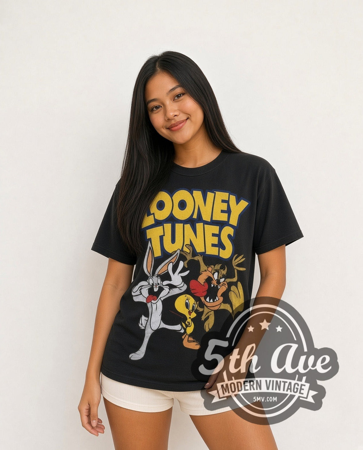 Model wearing the Looney Tunes Logo Bugs Tweety Taz Crew all-over-print vintage cartoon t-shirt in black