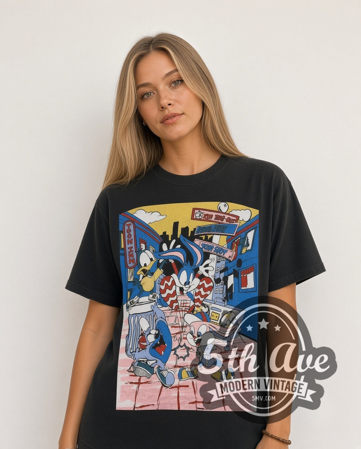 Model wearing the Tiny Toon Adventures Toon Town Crew all-over-print vintage cartoon t-shirt in black