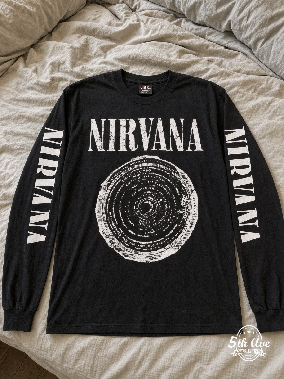 ETS LS 29 Nirvana Vestibule Circle long sleeve vintage tee laid on a bed