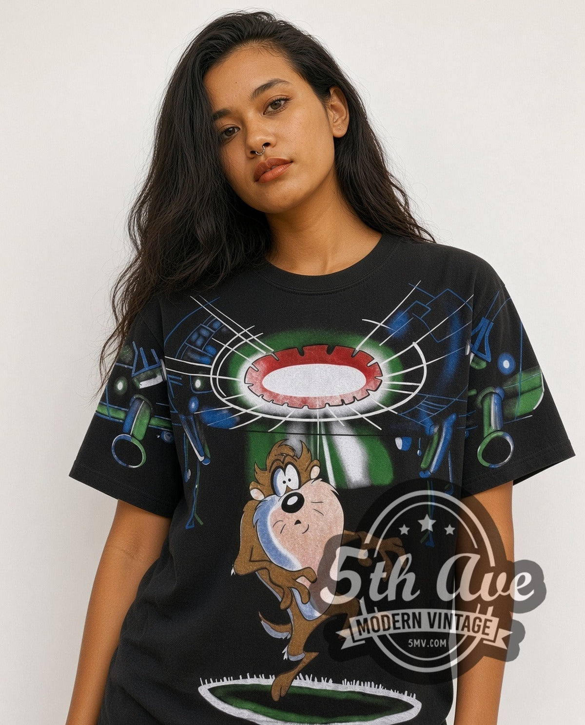 Model wearing the Looney Tunes Taz UFO Abduction all-over-print vintage cartoon t-shirt in black