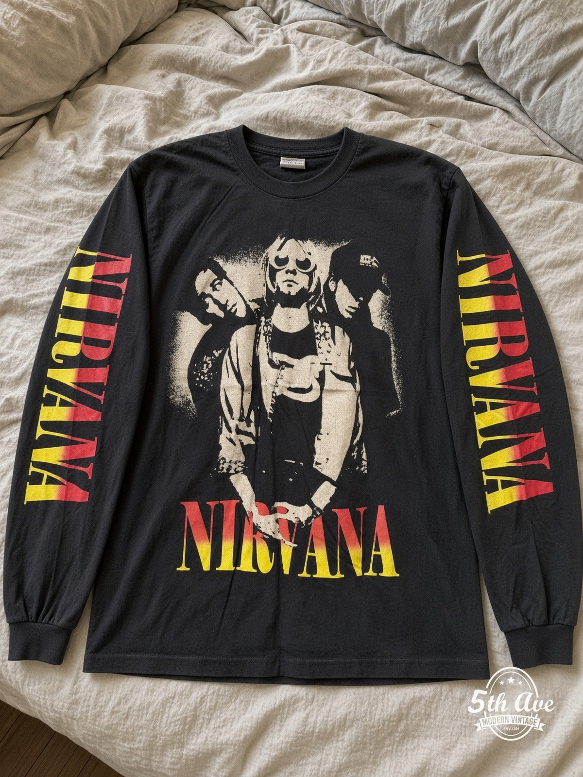 ETS LS 32 Nirvana Trio Photo long sleeve vintage tee laid on a bed