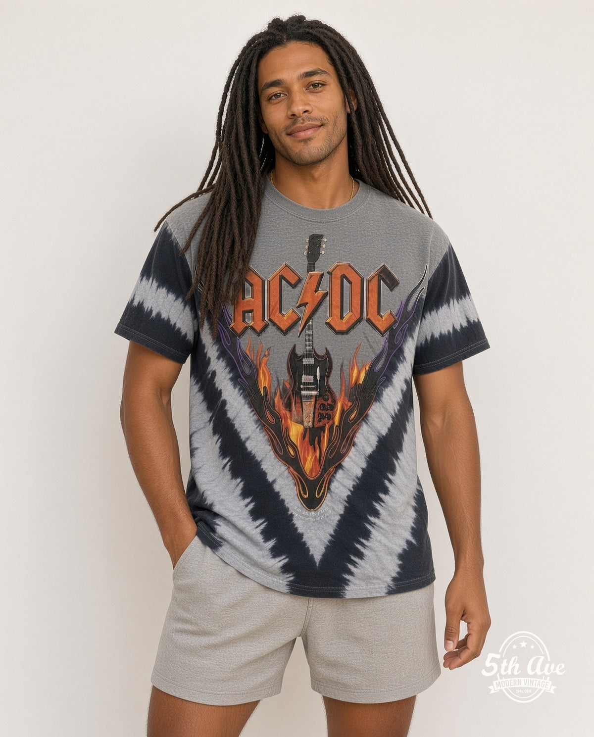 Model wearing AC/DC Flaming Winged Guitar Tie-Dye V Grey vintage band tee