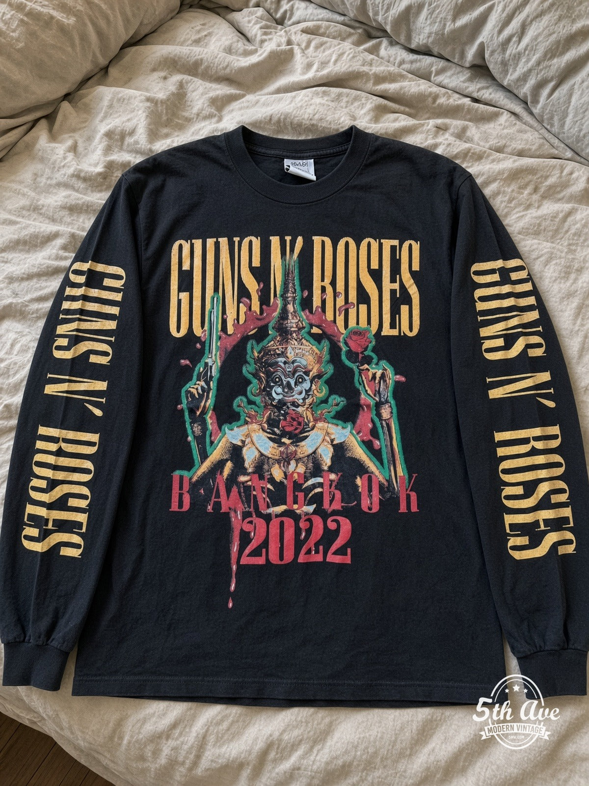 ETS LS 39 Guns N' Roses 2022 Concert Date long sleeve vintage tee laid on a bed