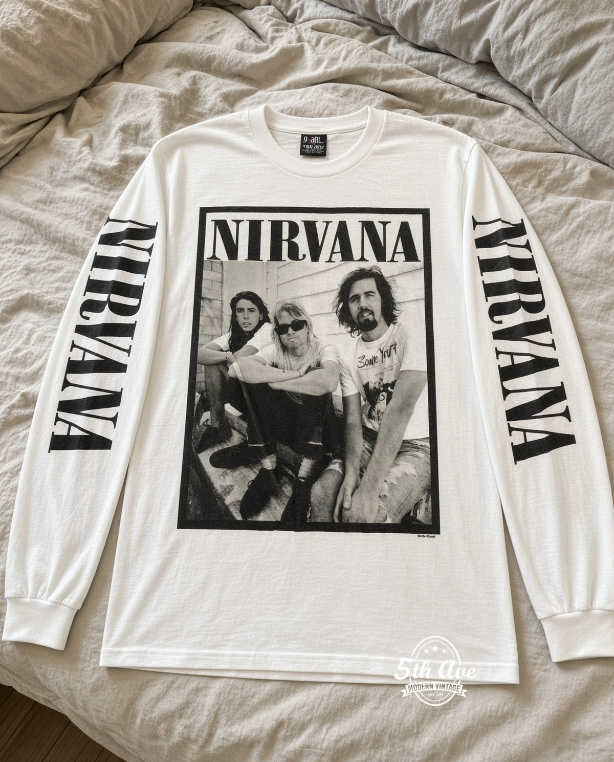 ETS LS 61 Nirvana Seated Trio long sleeve vintage tee laid on a bed