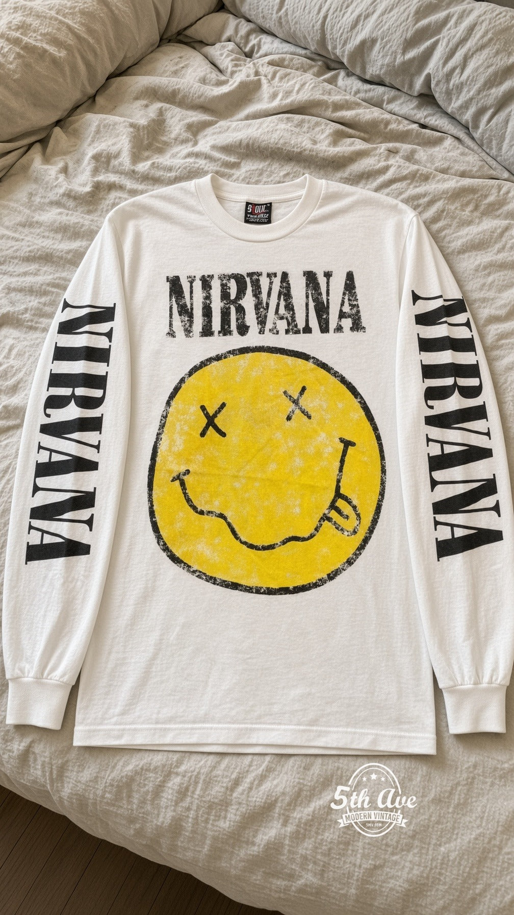 ETS LS 76 Nirvana Smiley long sleeve vintage tee laid on a bed