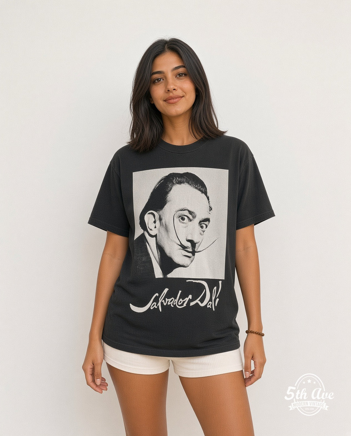 Model wearing the Salvador Dalí Avida Dollars graphic tee in black