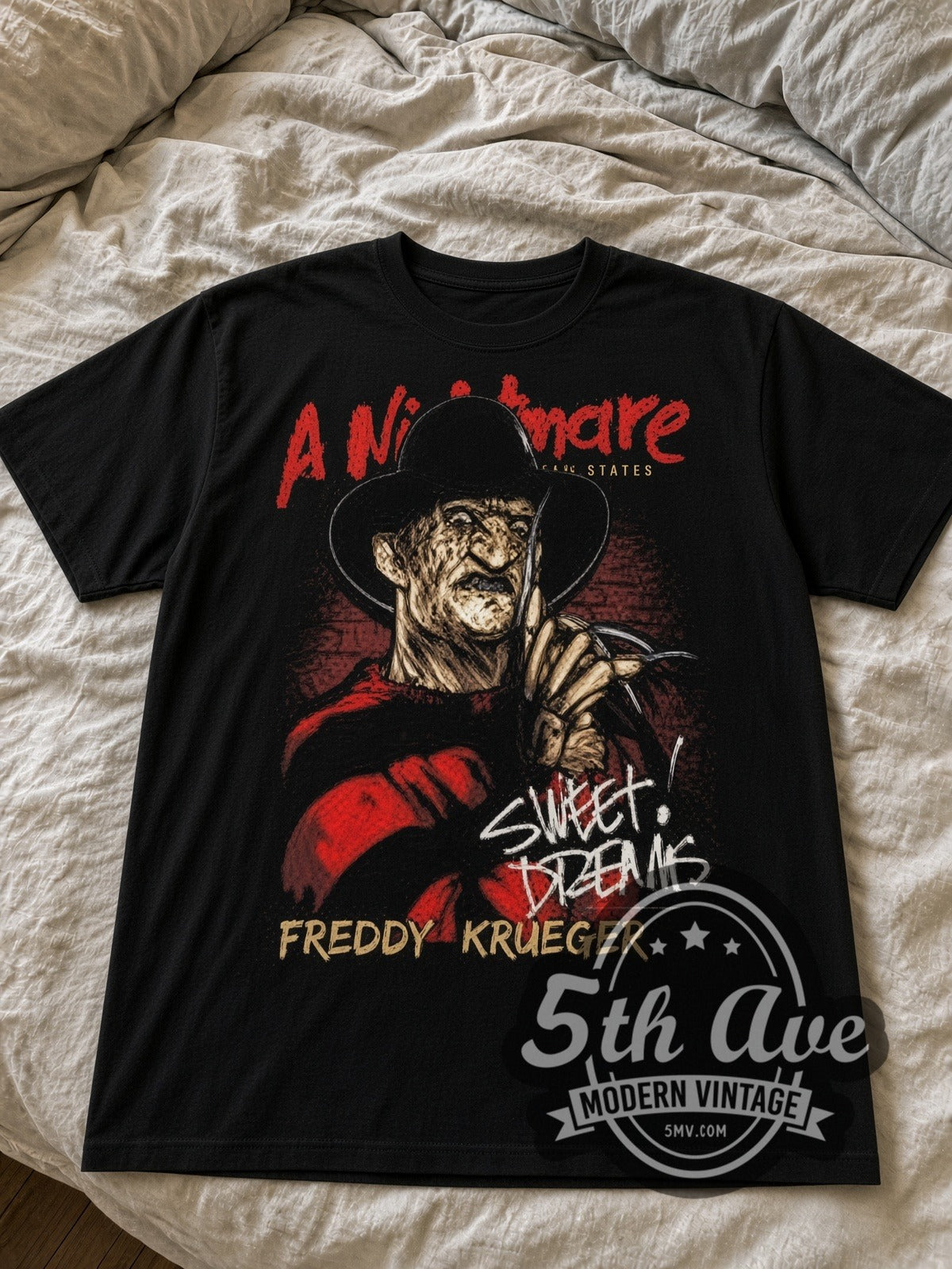 A Nightmare on Elm Street Freddy Krueger Sweet Dreams black graphic tee laid flat on linen bed