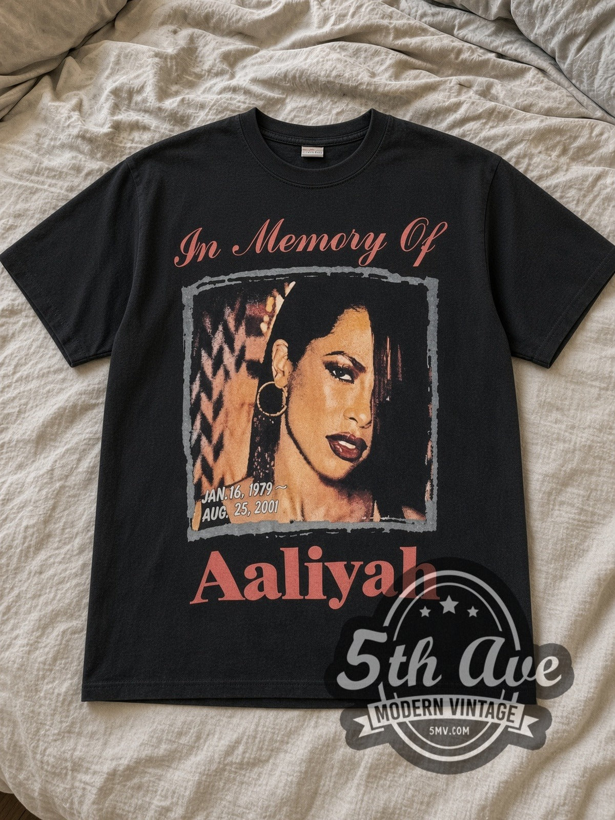 Black Aaliyah Try Again Vintage Band T-Shirt laid flat on a linen bed