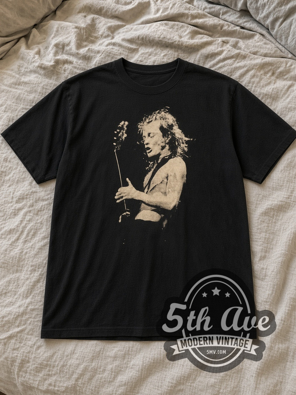 Black AC/DC Angus Young Shirtless Guitar Portrait Vintage Band T-Shirt laid flat on a linen bed