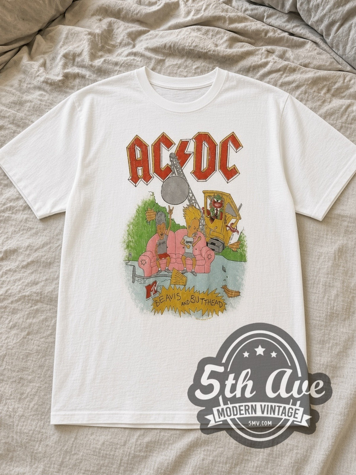 White AC/DC x Beavis and Butt Head Pink Couch White Tee Wrecking Ball Vintage Band T-Shirt laid flat on a linen bed