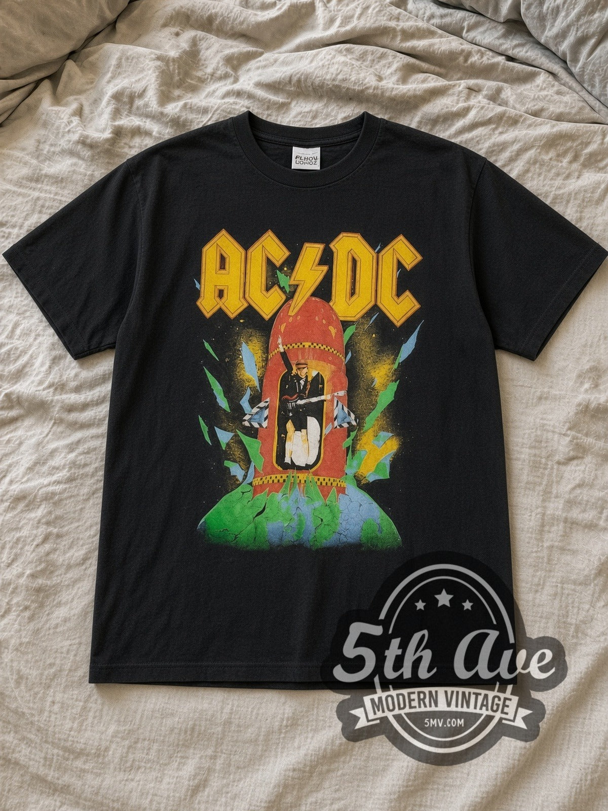 Black AC/DC Blow Up Your Video Red Rocket Blimp Vintage Band T-Shirt laid flat on a linen bed