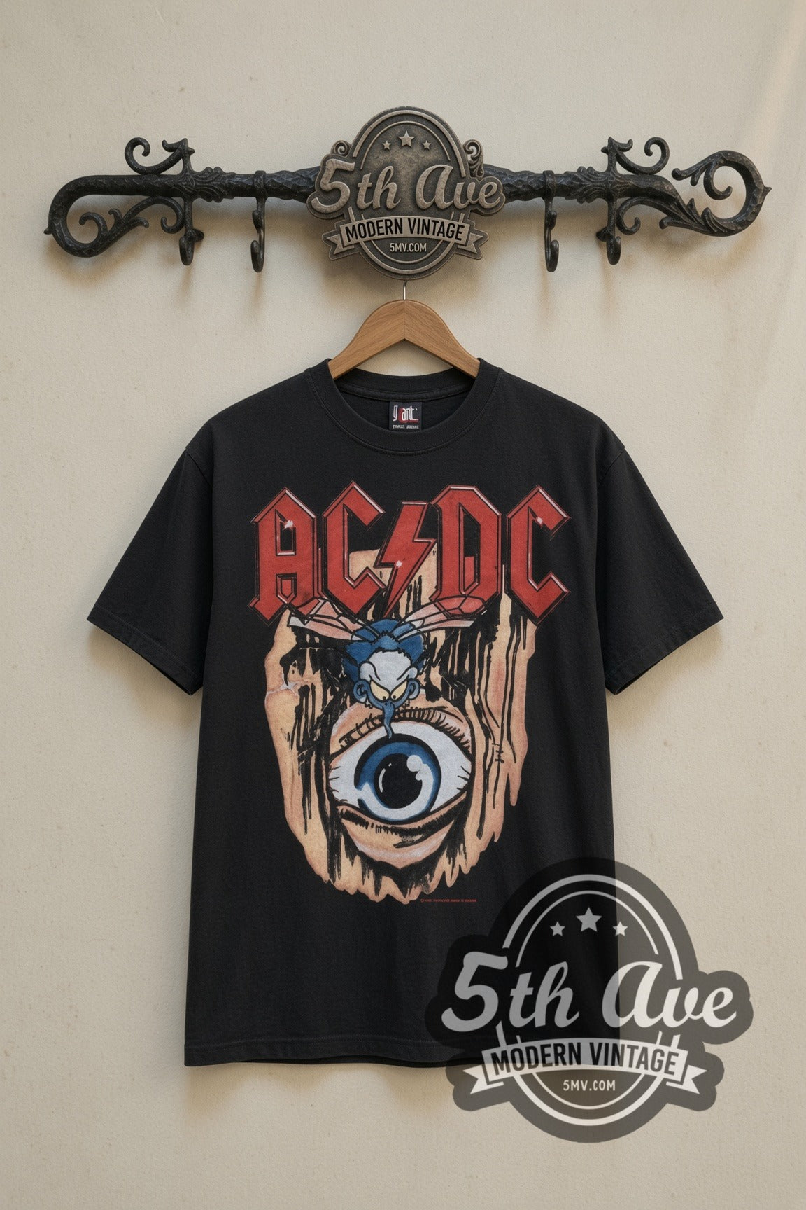 AC/DC Fly on the Wall 1985 Tour Eye vintage band t-shirt in black, front view on a display rack