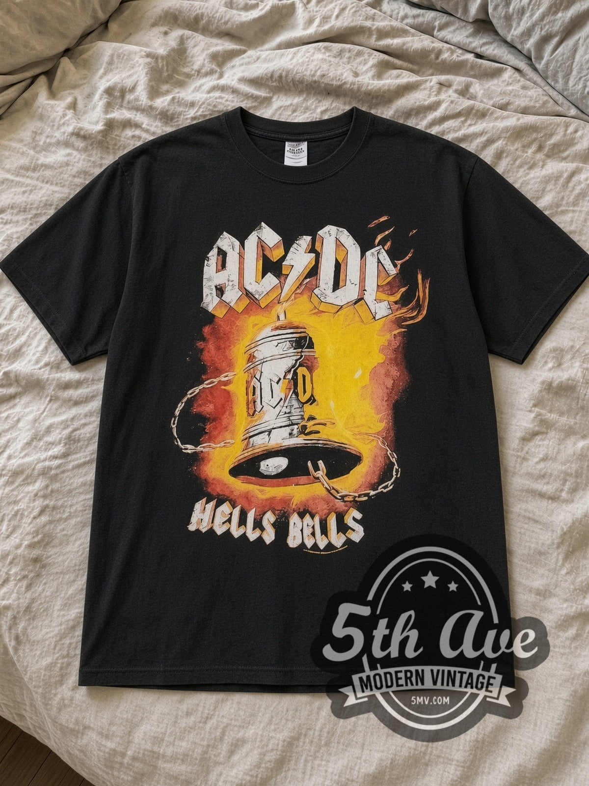 Black AC/DC Hells Bells Power Up Tour Vintage Band T-Shirt laid flat on a linen bed