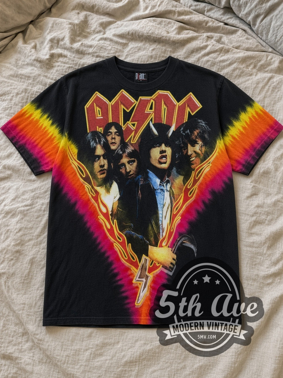 Black AC/DC Highway to Hell Flame V Pink Yellow Tie Dye Vintage Band T-Shirt laid flat on a linen bed