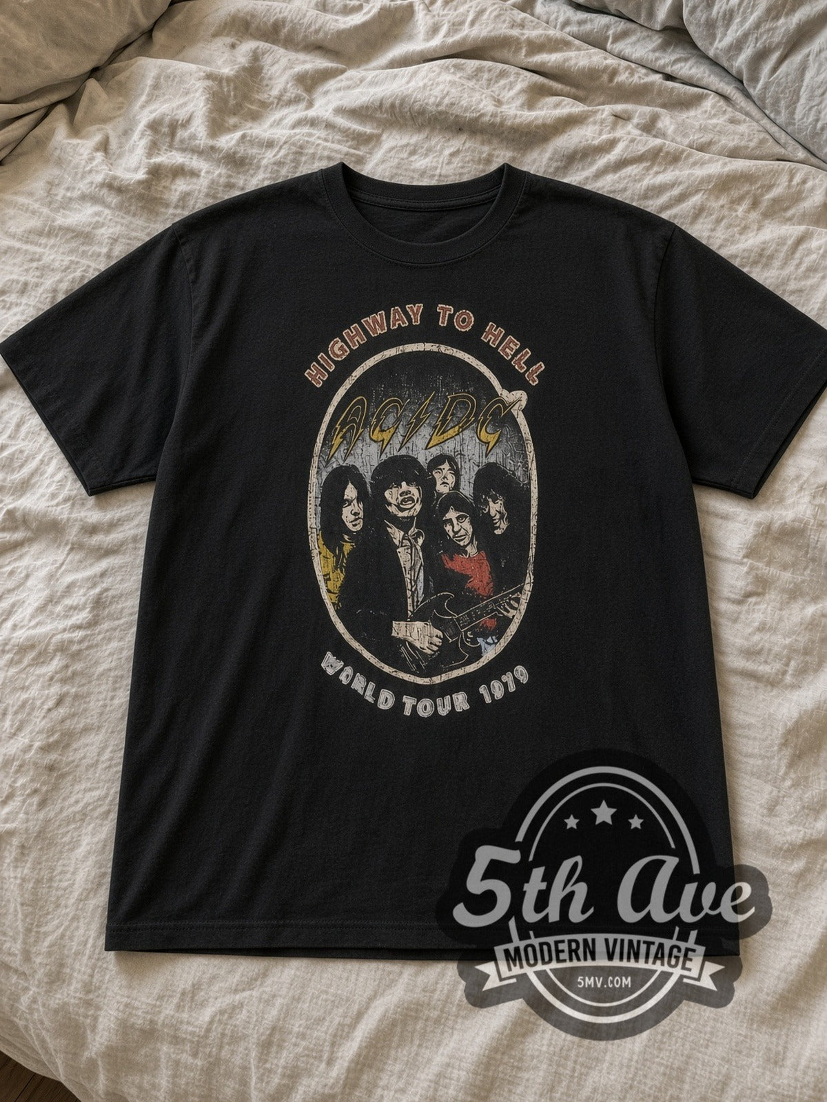 Black AC/DC Highway to Hell 1979 World Tour Oval Vintage Band T-Shirt laid flat on a linen bed