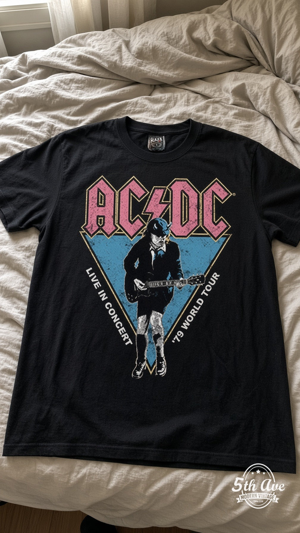 AC/DC Live in Concert '79 vintage t-shirt laid on bed