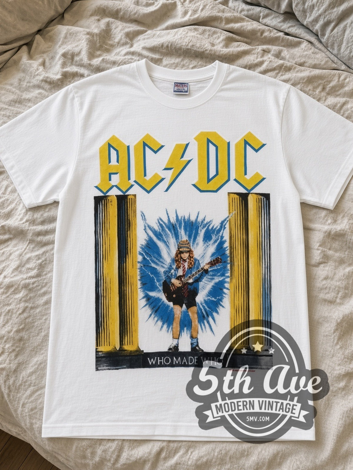 AC/DC Who Made Who Lightning Angus band t-shirt in white laid flat on a bed, front artwork