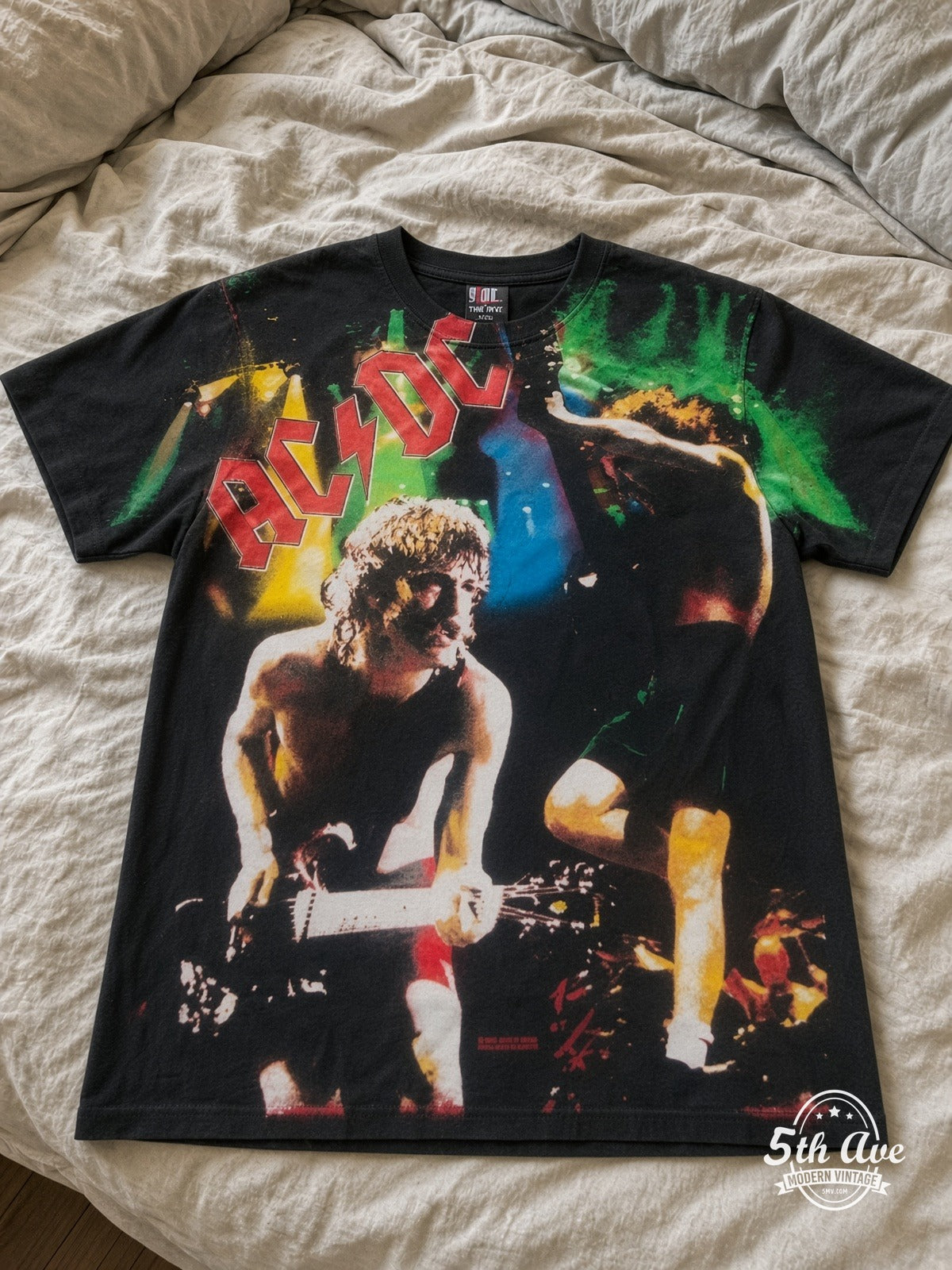 AC/DC Angus Money Rain all over print vintage tee laid on bed