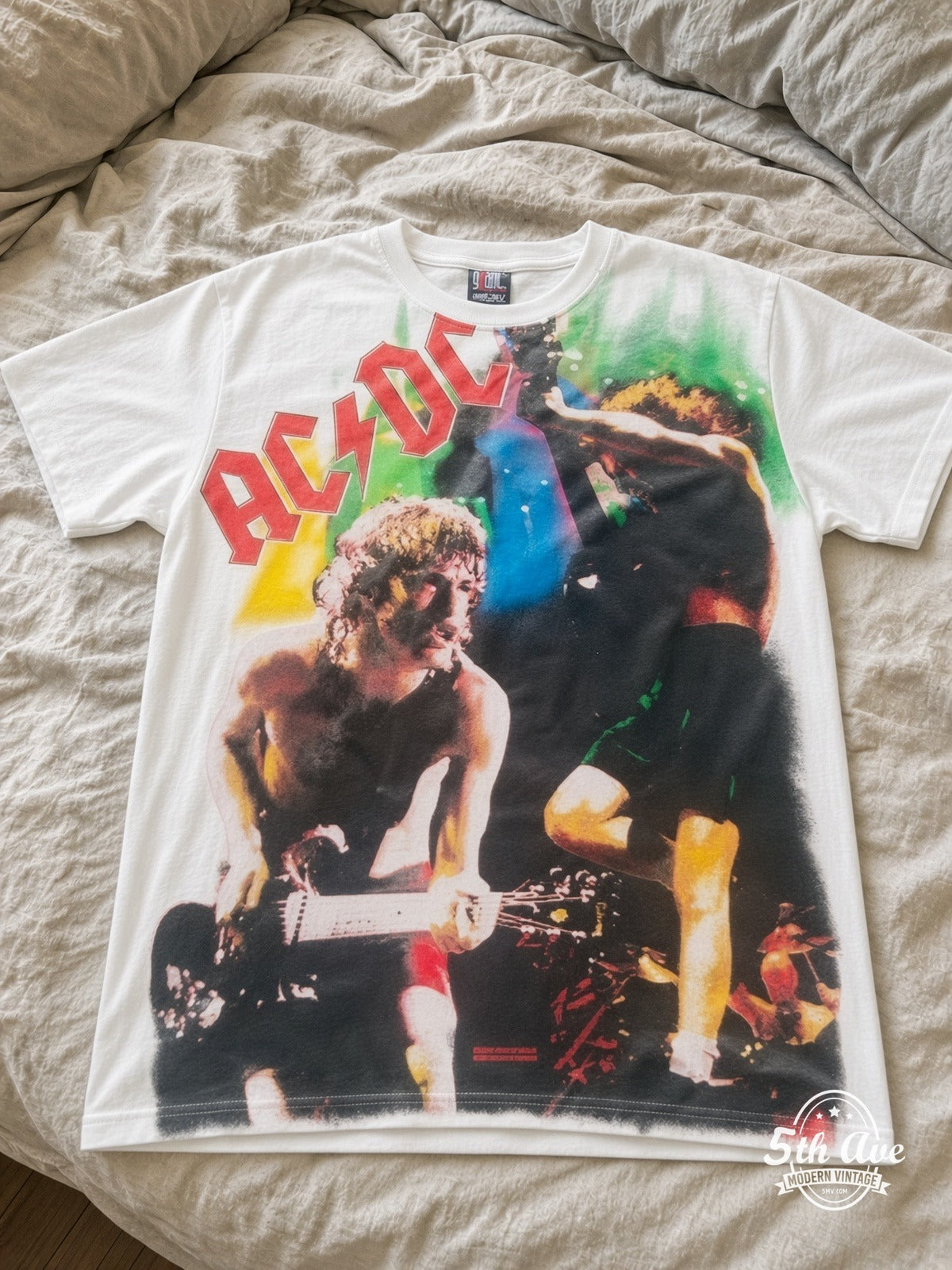 AC/DC Angus Money Rain White all over print vintage tee laid on bed