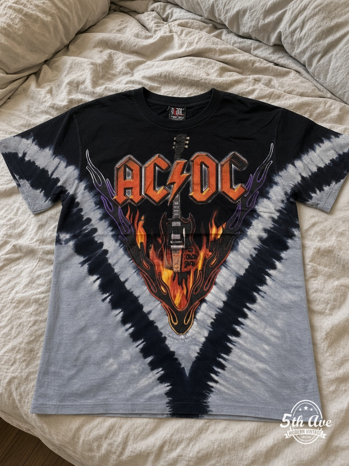 AC/DC Hells Bells Tie-Dye V Grey all over print vintage tee laid on bed