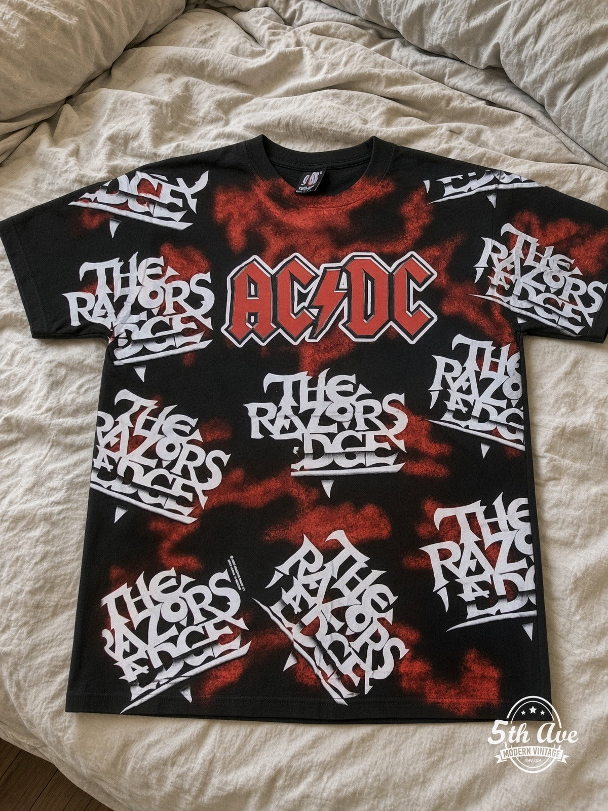 AC/DC Razors Edge Logo Collage all over print vintage tee laid on bed