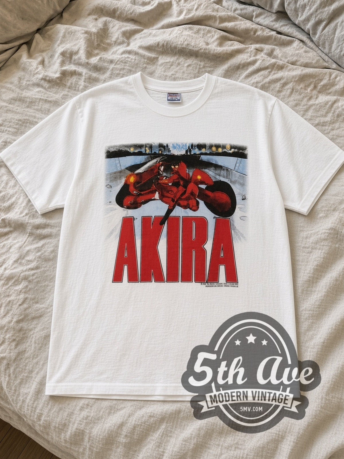 White Akira Kaneda Motorcycle Comic Back Vintage Anime T-Shirt laid flat on a linen bed