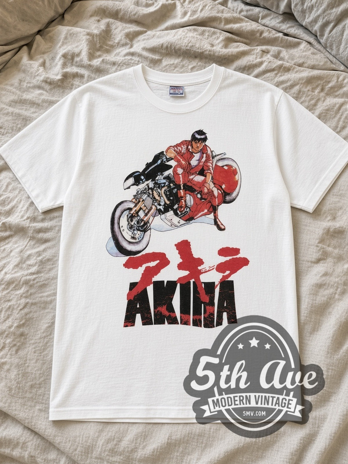 White Akira Shotaro Kaneda Vintage Anime T-Shirt laid flat on a linen bed